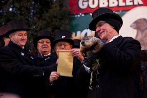 Group photo including man holding Punxsutawney Phil
